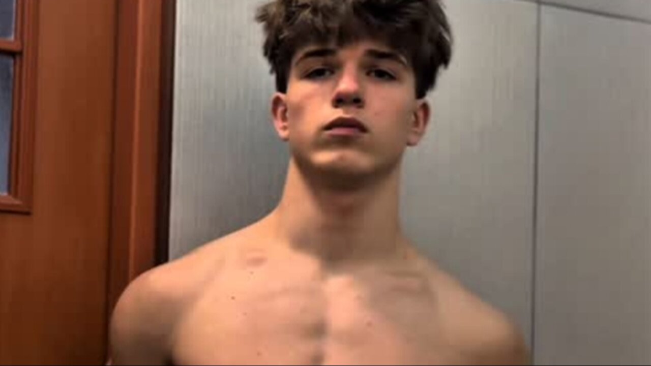 Teen boy flexing muscles