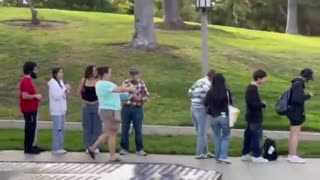 A video of Democrat Katie Porter handing out free stuff to young students waiting