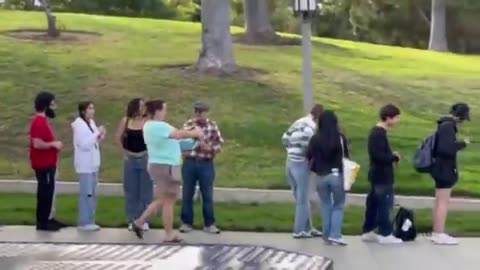 A video of Democrat Katie Porter handing out free stuff to young students waiting