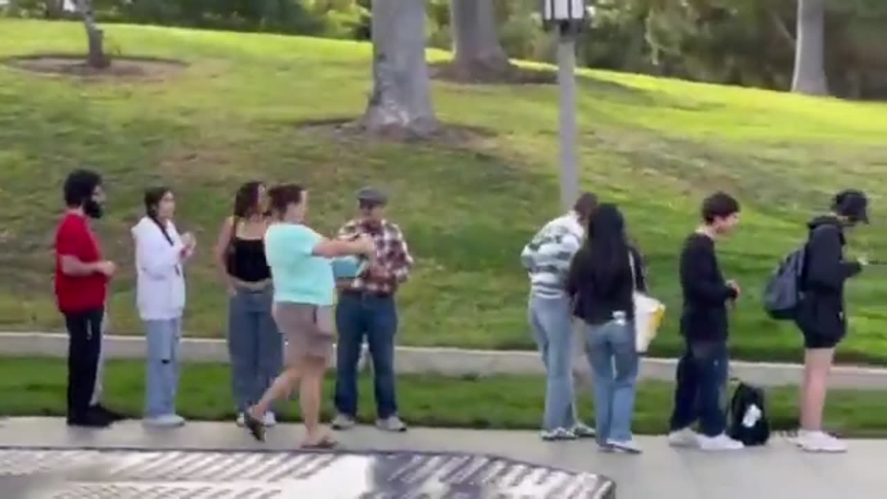 A video of Democrat Katie Porter handing out free stuff to young students waiting