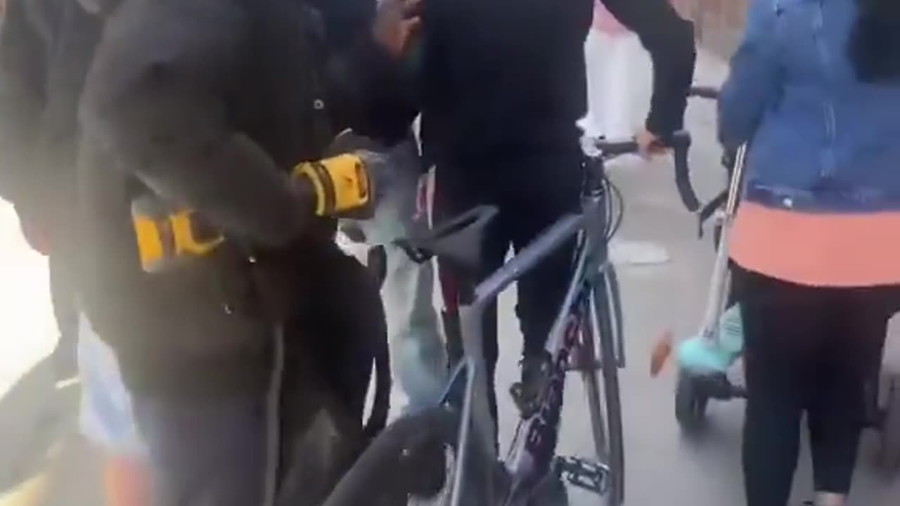 Blacks steal bikes, men watch