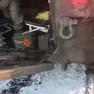 Examining Damaged Ukrainian APC Returning from Battle