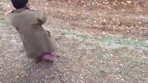 Turkish soldier gives chocolate to a Syrian child