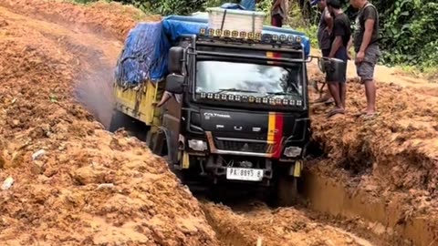 The truck went through a steep road full of mud