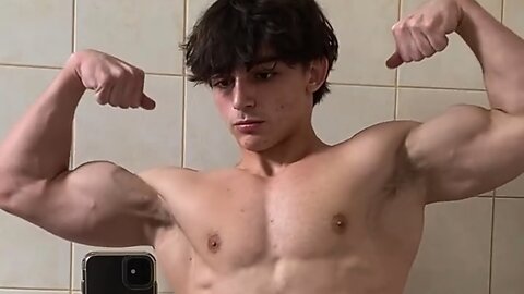 Teen bodybuilder flexing muscles