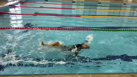 Woman Gives Backstroke Her All