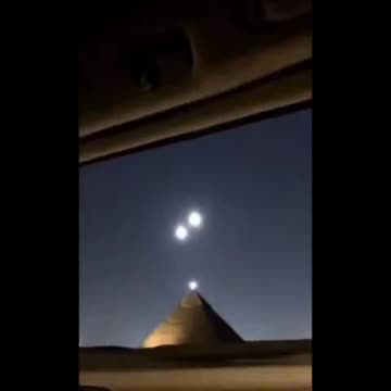 UFOs over the pyramids at Giza, Egypt.