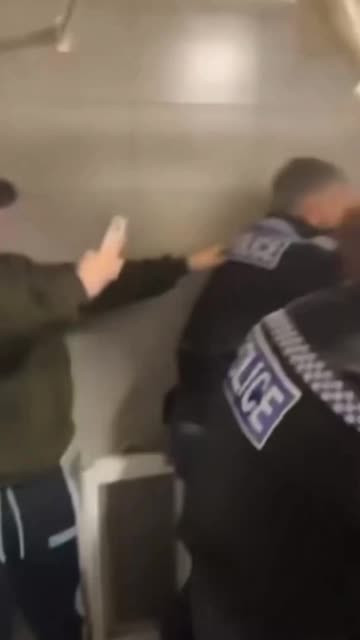 British police attempt to arrest a young man for his Facebook posts.