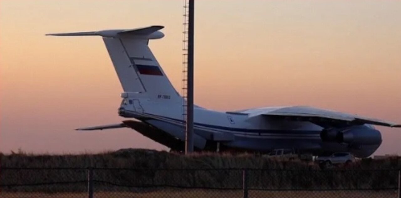 Russian planes are loaded with trucks and equipment at Qamishli airport in Syria