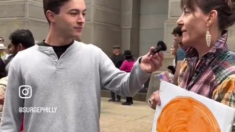 White liberal female boomer. She literally has no idea what she is protesting about