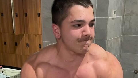 15 years old teen boy flexing muscles
