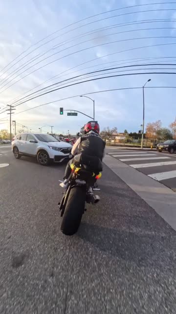 Inattentive Motorcyclist Nearly Hit By Turning SUV