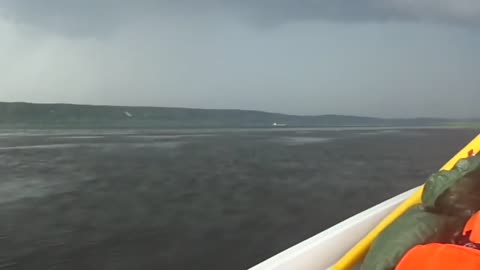 Escaping from a thunderstorm on a motorboat