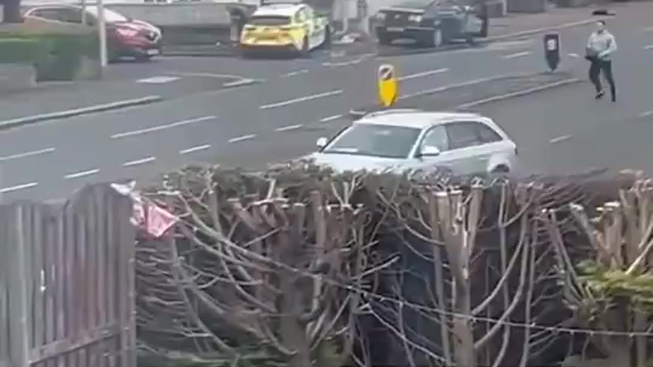 British police flee chased by man with chainsaw.