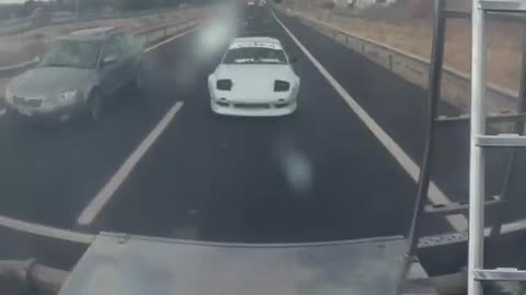 Car Winks At Itself In Truck's Reflection