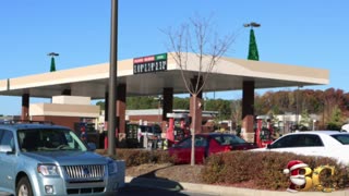 Gas prices fall to four-year lows as millions embark on holiday road trips