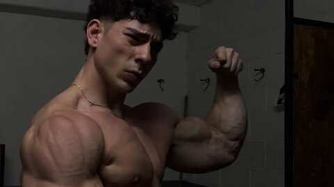 Young bodybuilder flexing massive biceps