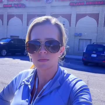 Woman records the Muslim call to prayer being broadcast over loudspeakers in...