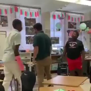 Teacher breaks up fight by body slamming both students.