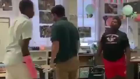 Teacher breaks up fight by body slamming both students.
