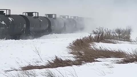 a train plowing through massive snowdrifts