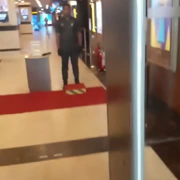 entering the checking and frisking area of theatre...