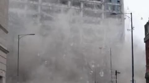 Building collapses and people run