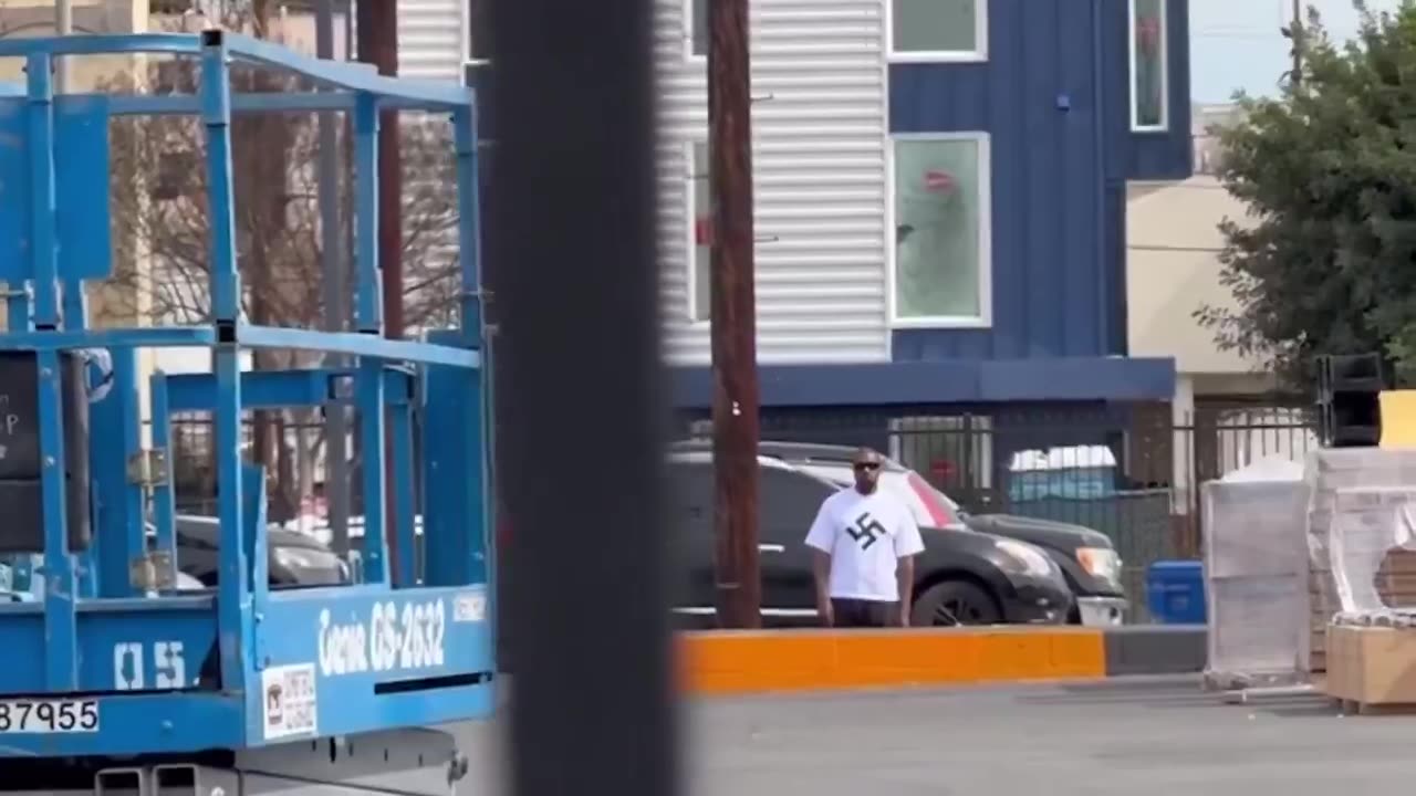 Ye doing a Sieg Heil while wearing a swastika T-shirt