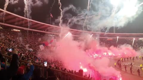 Crvena Zvezda fans waving flags with the map of Greater Serbia including Kosovo