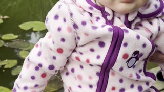 Baby Kayla enjoying a calm moment by the family pond 🌿