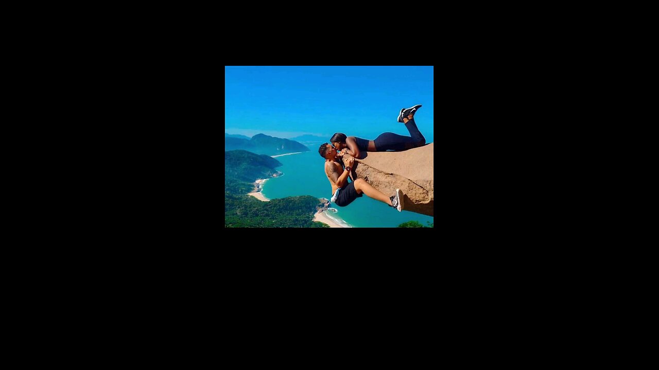 Couple Kiss On Cliff Edge