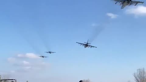 Two pairs of Su-25s of the Russian Air Force at low altitude somewhere on the front line.