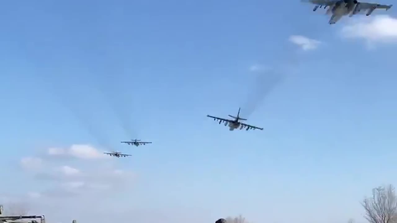 Two pairs of Su-25s of the Russian Air Force at low altitude somewhere on the front line.