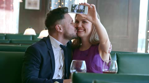 Couples on date filming themselves and kissing