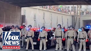 LA police in riot gear face off with anti-Trump protesters