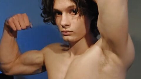 Young aesthetic bodybuilder flexing muscles