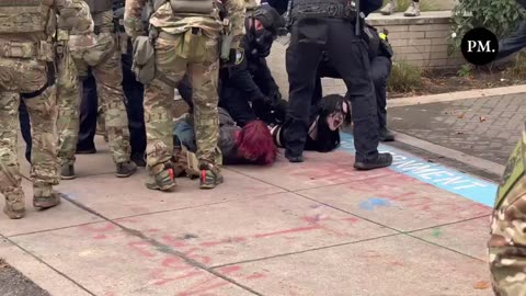 Order out of chaos: Federal police make several arrests outside the ICE facility in Portland.
