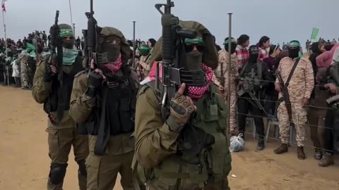 Al-Qassam Brigades soldiers carrying captured Israeli army weapons