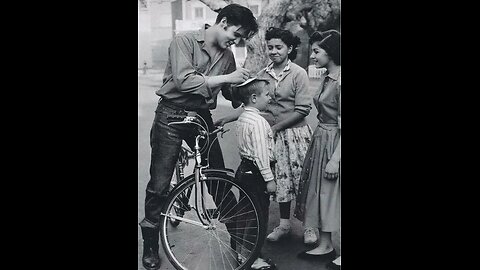 Elvis signing a boy’s head, 1959.