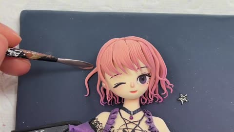 Use clay to mold a shiny dark little witch,she is really super cute