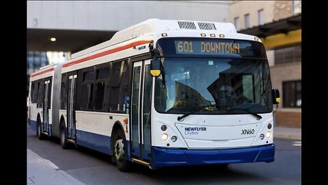 A photograph of a Newflyer Citybus XN60 parked in an urban setting, showing route and destination