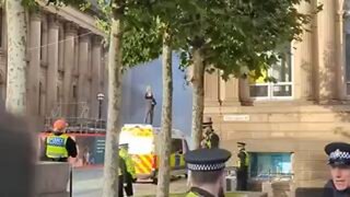 Meanwhile in the UK, a muslim sets fire to a police van and stands on top of it waving a Quran