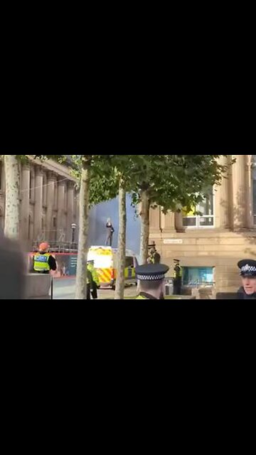 Meanwhile in the UK, a muslim sets fire to a police van and stands on top of it waving a Quran