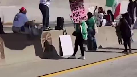 Street level view of the 101 Freeway takeover by anti-ICE protestors in Los Angeles