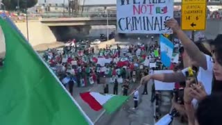 Los Angeles police, dressed in riot gear, are at a standoff as thousands of protesters march against ICE deportations.