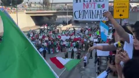 Los Angeles police, dressed in riot gear, are at a standoff as thousands of protesters march against ICE deportations.