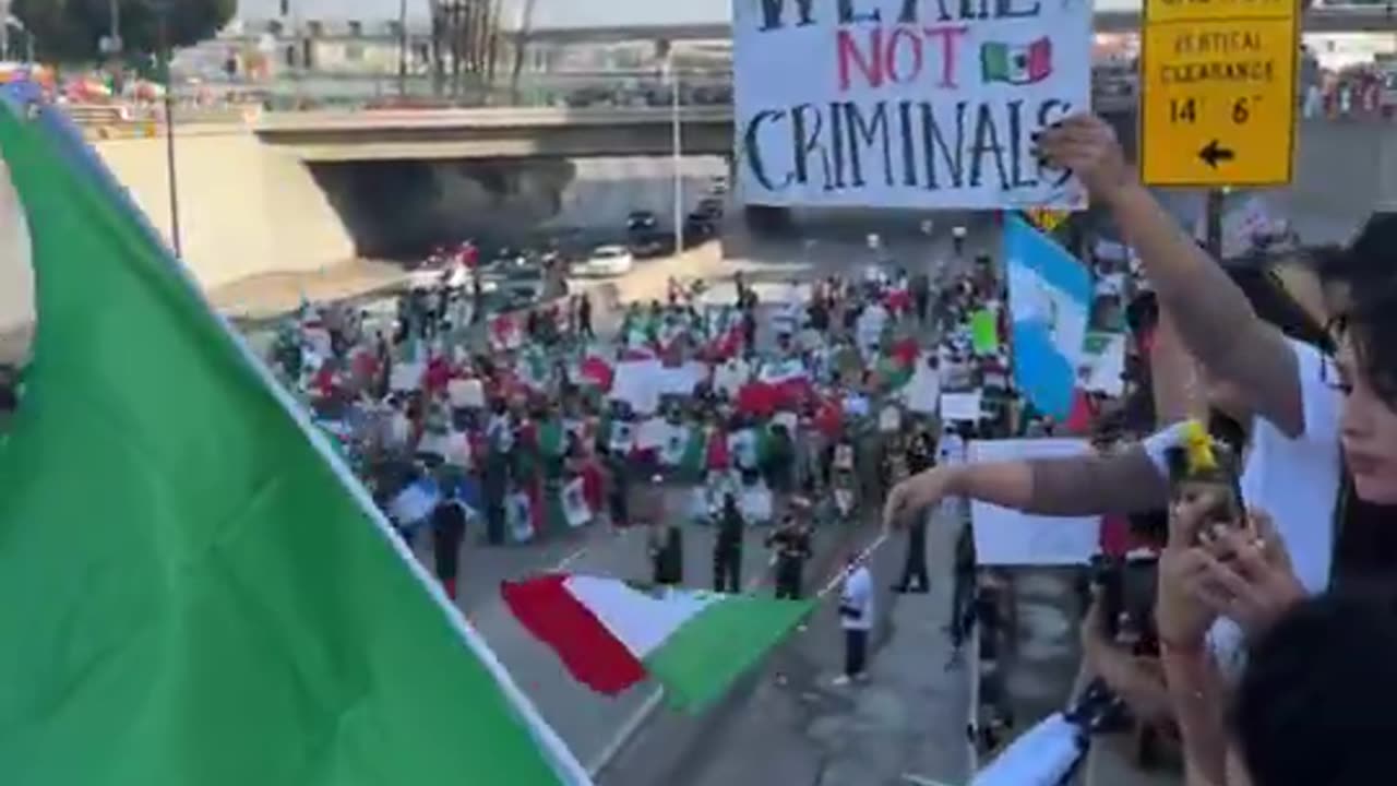 Los Angeles police, dressed in riot gear, are at a standoff as thousands of protesters march against ICE deportations.