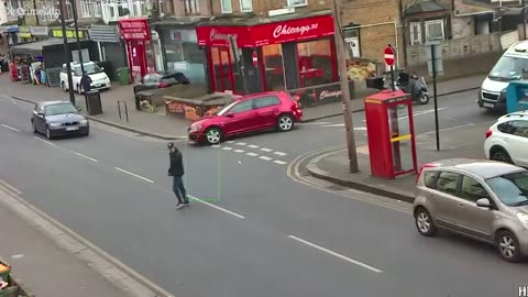 Moment man is flung through air after car hits him as he crosses road