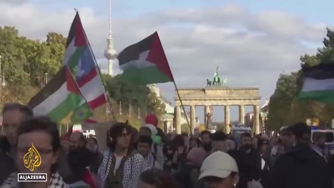 German Chancellor in Israel: Critics slam state visit to 'war criminal' Netanyahu