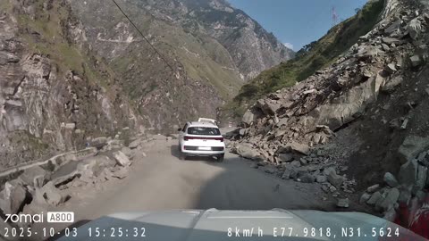 Boulder Falls Across Car Hood On Mountain Road